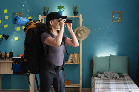 woman with binoculars preparing hiking trip