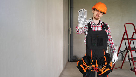 male laborer, builder or repairman ready for repairing or building showing rejecting gesture by stop...