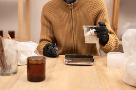 Weighing dry gypsum powder on electronic scales for handmade decor