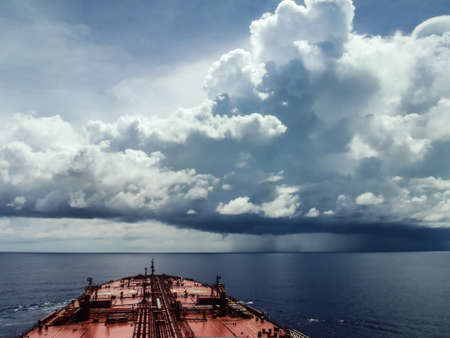 An oil tanker sails in the waters of Indian ocean facing a terrible storm on its wayの写真素材