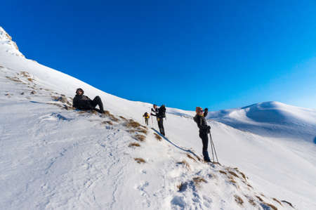 A group of climbers resting after a long distance hiking and enjoying the breathtaking viewのeditorial素材