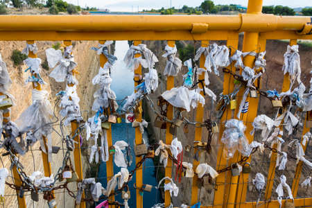 Padlocks on the bridge over the Corinthian canal in Greece. Lovers hanging lockers on the bridge over the Corinth canal promising eternal loveのeditorial素材