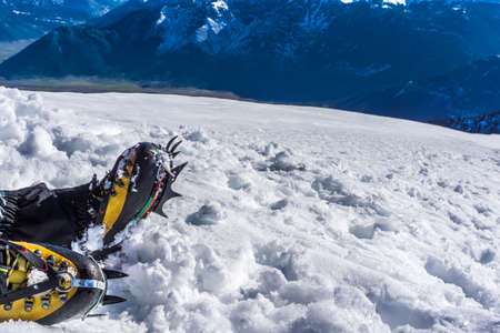 Crampons close up for extreme hiking on snow covered mountains. Hiking on mountain Dourdouvana in Peloponnese Greeceの写真素材