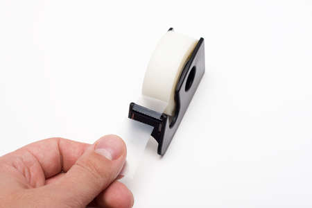 Tearing piece of sticky tapeの写真素材