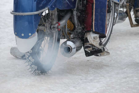 rear view on a running motorcycle for the ice Speedway with driverの写真素材
