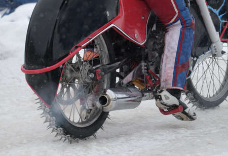rear view on a running motorcycle for the ice Speedway with driverの写真素材