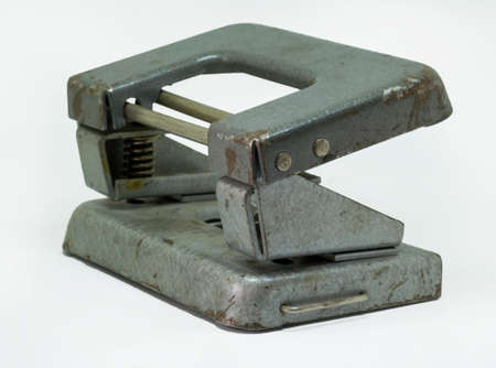 vintage tool for piercing holes in paper ( punch ) isolated on a white backgroundの写真素材