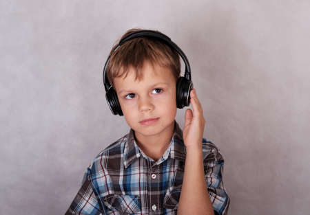 European boy listening to music on headphones, eyes closedの写真素材