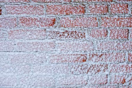 wall of red brick with adhering white snow. backgroundの写真素材