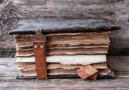 vintage Church book with a leather clasp on a wooden tableの写真素材
