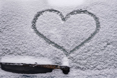 the heart pattern on the back covered with snow glass of the car