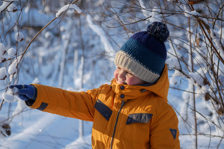 Cute European boy on a walk on a Sunny winter dayの写真素材