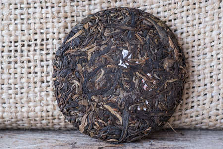 natural Chinese Puer tea compressed into a pancake on the tableの写真素材