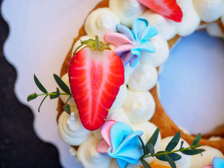 Homemade cake with cream and strawberries in the form of figures eightの写真素材