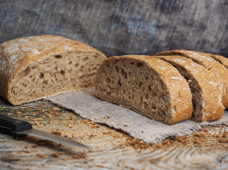 chiabatta bread of rye and wheat flour on a wooden table of old boards