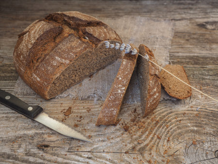 homemade unleavened bread from rye and wheat flour on a wooden table of old boardsの写真素材