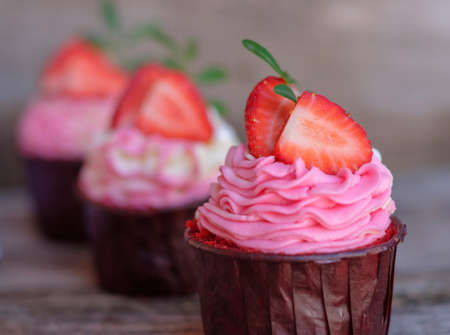 beautiful wedding cupcakes with white pink cream and strawberriesの写真素材