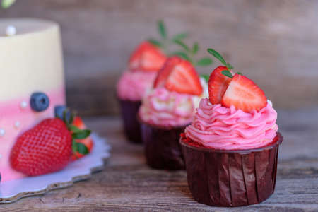 beautiful wedding cupcakes with white pink cream and strawberriesの写真素材