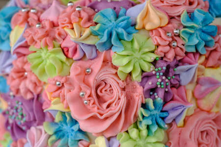 cream colored texture in the form of flowers on the birthday cake. close-up pattern.の写真素材
