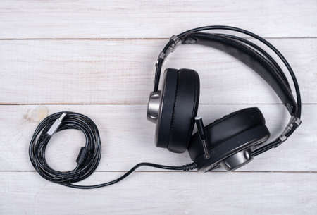 black large headphones for music and computer games with microphone and usb cable on white background top viewの写真素材