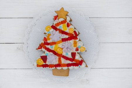 beautiful homemade cake for Christmas and New year in the form of a Christmas tree decorated with...