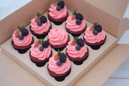 beautiful cupcakes with pink cream in a cardboard boxの写真素材