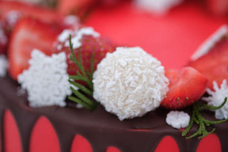 beautiful homemade red cake with fresh strawberry berries on white background. wedding cake, birthday cake, holiday dessertの写真素材
