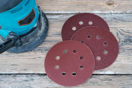 electric grinder and grinding wheels on old wooden Boardの写真素材