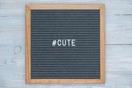 gray felt Board letters with the English word cute and the sign of the hashtagの写真素材