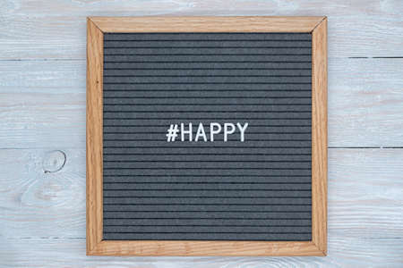 gray felt Board letters with the English word happy and the sign of the hashtagの写真素材