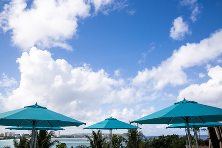 blue parasols with blue sky background in a sunny dayの写真素材