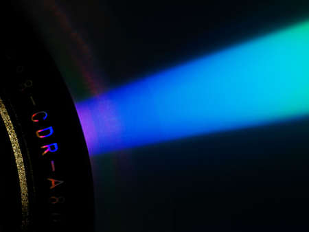 CD surface with microscopic pits burnt by laser representing zeroes and onesの写真素材