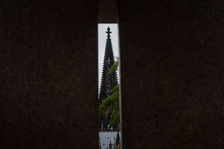 Cologne, Germany - March 10, 2019: View on famous Cologne Dome through a split in wall. Concept of...