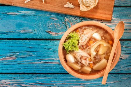 Soup in a wooden plateの写真素材