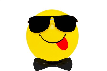yellow ball in black glasses with a smileの写真素材