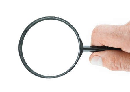 Hand holds a magnifying glass with clipping pathsの写真素材