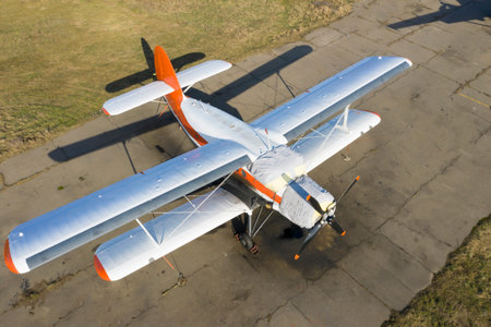 A small plane stands in the parking lot of an old airfield. Wings. Airport. Airfield. Flights by...