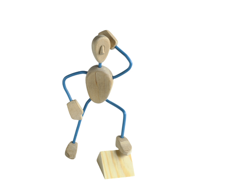 toy from wood in the form of a man. on a white background. in a pose. Funny mannequin for your projectの写真素材