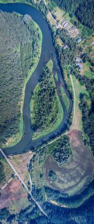 Aerial view of a small river in the middle of the forestの写真素材