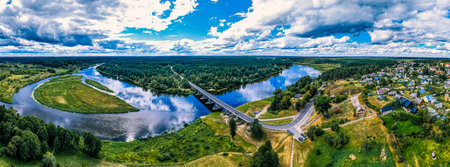 Aerial panorama of the bridge over the river. Beautiful summer landscape.