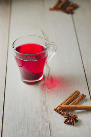 Hibiscus tea on a wooden table on a background of cinnamon and Bodeanの写真素材