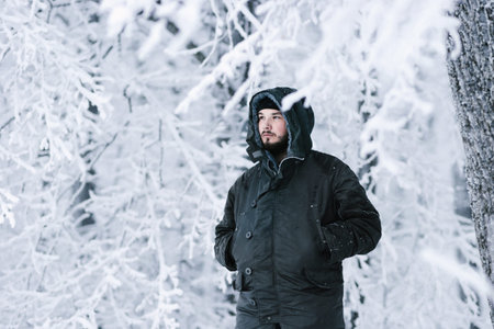 a man in a cold snowy forest