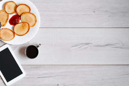 Tasty pancakes with coffee cup on white wood tableの写真素材