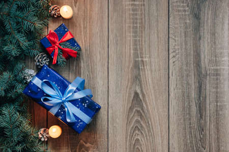 New Year composition View from above. Herringbone toys with candles, boxes on wooden background, with space for textの写真素材