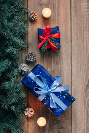 New Year composition View from above. Herringbone toys with candles, boxes on wooden background, with space for textの写真素材