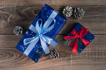 Gift box and a cone on a Christmas backgroundの写真素材