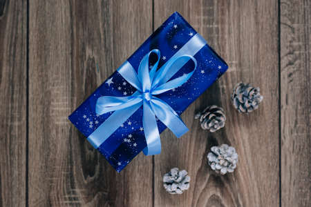 Gift box and a cone on a Christmas backgroundの写真素材