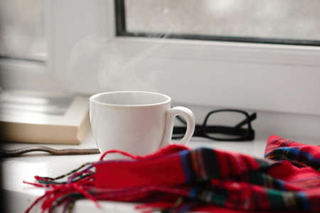 cup of black coffee on a white background, red cloth bookの写真素材