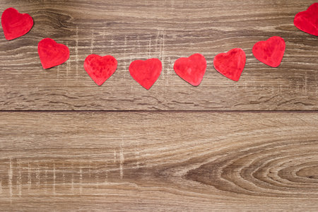 red heart on a wooden background, with space for text