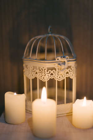 White burning candle, a fire in the background cellの写真素材